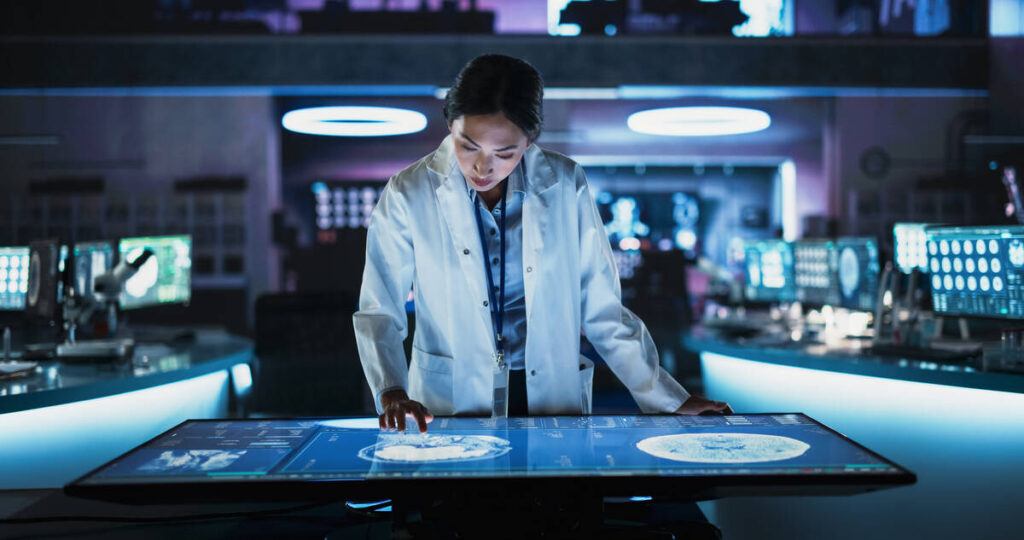 Woman scientist looking at display on table