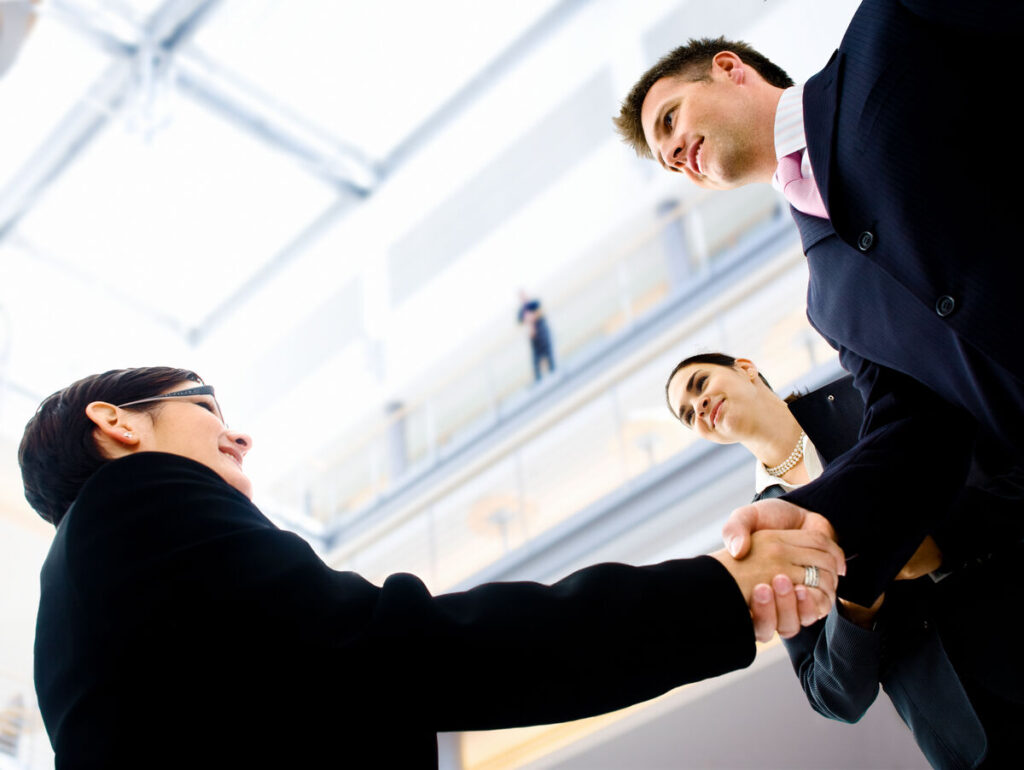 People in business suits shaking hands