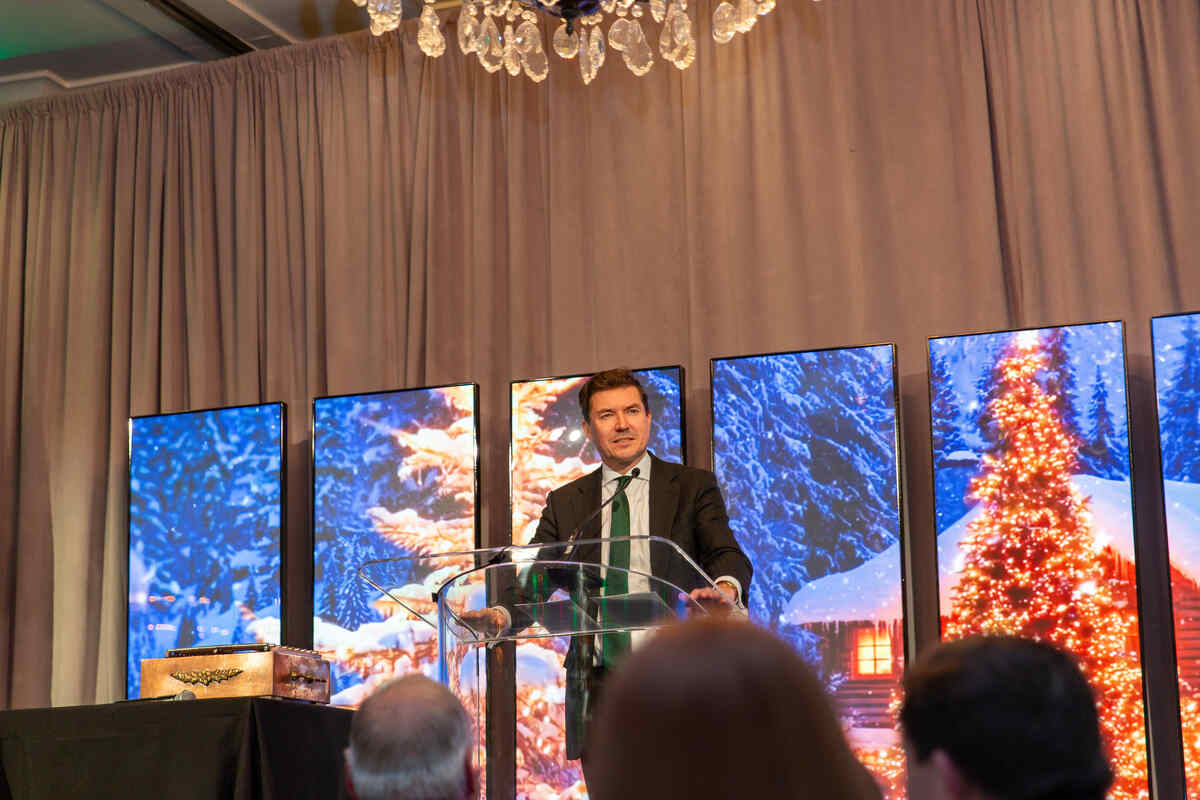 Man standing at podium on stage.