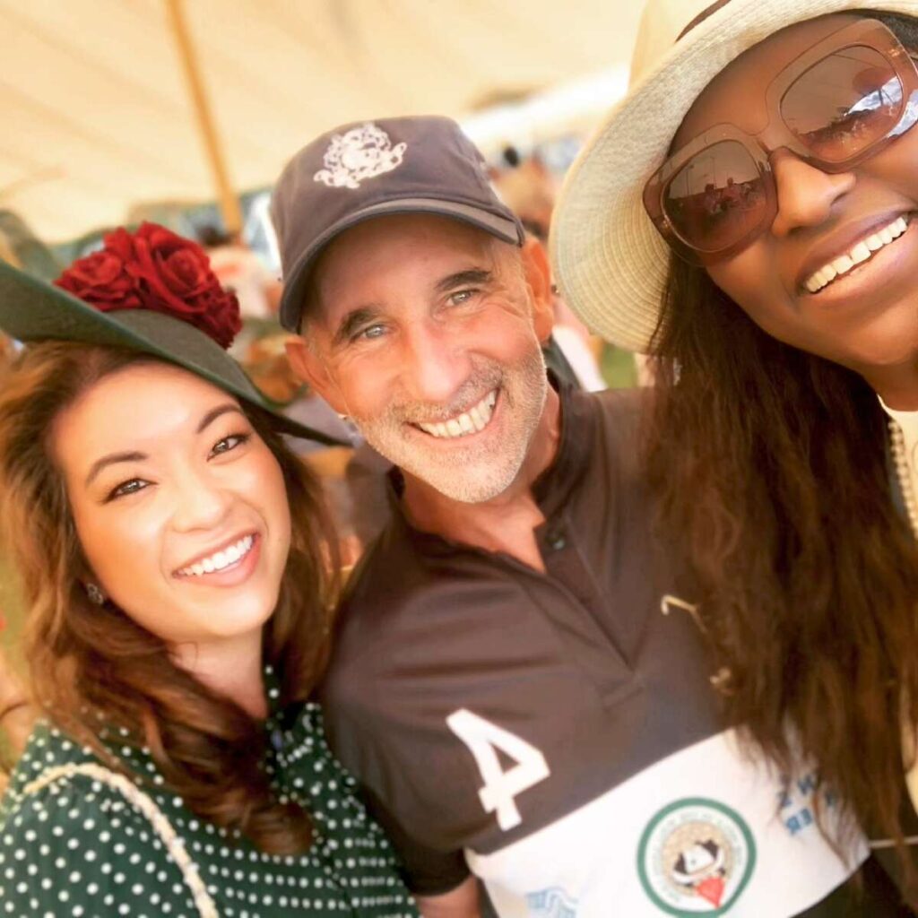 Two women with a polo player